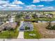 House with gray roof and two car garage is situated on a canal at 60 White Marsh Ln, Rotonda West, FL 33947