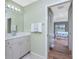 Bathroom with vanity, and view into bedroom at 60 White Marsh Ln, Rotonda West, FL 33947