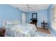 Bedroom with queen bed, ceiling fan, and wood-look floors at 60 White Marsh Ln, Rotonda West, FL 33947