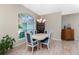 Dining room features a light wood table with blue chairs and hardwood floor at 60 White Marsh Ln, Rotonda West, FL 33947