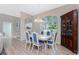 Dining room with light wood table and blue chairs, hardwood floor at 60 White Marsh Ln, Rotonda West, FL 33947