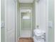 Bright hallway with linen cart and access to bathroom at 60 White Marsh Ln, Rotonda West, FL 33947