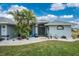 Single story house with gray exterior and nicely landscaped yard at 60 White Marsh Ln, Rotonda West, FL 33947