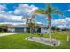 Single story house with gray exterior and nicely landscaped yard at 60 White Marsh Ln, Rotonda West, FL 33947