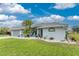Single story house with gray exterior and nicely landscaped yard at 60 White Marsh Ln, Rotonda West, FL 33947