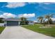 Single story house with gray exterior and nicely landscaped yard at 60 White Marsh Ln, Rotonda West, FL 33947