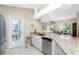 Kitchen with granite countertops, stainless steel appliances and access to backyard at 60 White Marsh Ln, Rotonda West, FL 33947