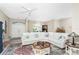 Bright living room featuring a large sectional sofa and a coffee table at 60 White Marsh Ln, Rotonda West, FL 33947