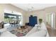 Living room with off-white sectional sofa, sliding doors to lanai at 60 White Marsh Ln, Rotonda West, FL 33947