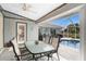 Covered patio overlooking the pool and backyard at 60 White Marsh Ln, Rotonda West, FL 33947