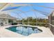 Screened pool with a kidney shape and backyard view at 60 White Marsh Ln, Rotonda West, FL 33947
