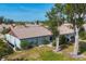 Rear view of house showing patio and well-maintained backyard at 610 Apple Ln, Englewood, FL 34223