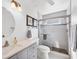 Modern bathroom with walk-in shower and gray vanity at 610 Apple Ln, Englewood, FL 34223