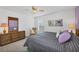King-size bed, dresser, and calming decor in bedroom at 610 Apple Ln, Englewood, FL 34223