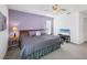 King-size bed, calming decor, and TV in this bedroom at 610 Apple Ln, Englewood, FL 34223
