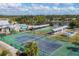 Aerial view of tennis courts, shuffleboard, pool, and clubhouse at 610 Apple Ln, Englewood, FL 34223