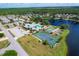 Aerial view of community with pool, tennis courts, and clubhouse at 610 Apple Ln, Englewood, FL 34223