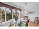 Bright dining room with glass table and view of backyard at 610 Apple Ln, Englewood, FL 34223