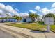 Cute light blue house with a nicely landscaped yard and two-car garage at 610 Apple Ln, Englewood, FL 34223