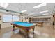 Community game room with pool tables and bookcases at 610 Apple Ln, Englewood, FL 34223