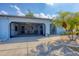 Home's exterior featuring a screened garage and lush landscaping at 610 Apple Ln, Englewood, FL 34223