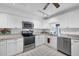 Modern kitchen with white cabinets, granite countertops, and stainless steel appliances at 610 Apple Ln, Englewood, FL 34223