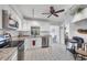 Modern kitchen with white cabinets, granite countertops, and stainless steel appliances at 610 Apple Ln, Englewood, FL 34223