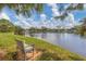 Serene lake view with bench at 610 Apple Ln, Englewood, FL 34223