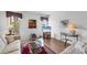 Spacious living room with hardwood floors, comfy sofas, and large windows at 610 Apple Ln, Englewood, FL 34223