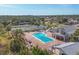 Community pool with hot tub, surrounded by lounge chairs at 610 Apple Ln, Englewood, FL 34223