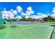 Community tennis court with green surface at 610 Apple Ln, Englewood, FL 34223