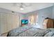 Bedroom with large closet and ceiling fan at 6699 San Casa Dr # S1, Englewood, FL 34224