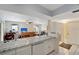 Modern kitchen with granite countertops and white cabinets at 6699 San Casa Dr # S1, Englewood, FL 34224