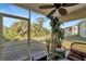 Relaxing screened patio with ceiling fan, offering view of lush greenery at 6699 San Casa Dr # S1, Englewood, FL 34224