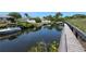 Wooden boardwalk leading to a peaceful canal at 6699 San Casa Dr # S1, Englewood, FL 34224