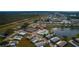 Aerial view showing community features including pool, tennis courts, and lake at 808 Tangerine Woods Blvd, Englewood, FL 34223