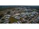 Aerial view of community with pool, tennis courts, and lake at 808 Tangerine Woods Blvd, Englewood, FL 34223