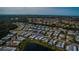 Wide aerial view showcasing the home's neighborhood and proximity to water at 808 Tangerine Woods Blvd, Englewood, FL 34223