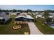 Aerial view of a single-Gathering home with carport and landscaped yard at 808 Tangerine Woods Blvd, Englewood, FL 34223