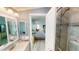 Bathroom with vanity, mirror, and access to a bedroom and walk-in shower at 808 Tangerine Woods Blvd, Englewood, FL 34223