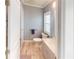 Bathroom with gray walls, wood-look flooring, and a walk-in shower at 808 Tangerine Woods Blvd, Englewood, FL 34223