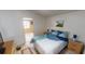 Spacious bedroom with a queen bed and access to another room at 808 Tangerine Woods Blvd, Englewood, FL 34223