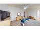 Bedroom with dresser, TV, and a ceiling fan at 808 Tangerine Woods Blvd, Englewood, FL 34223