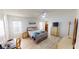 Spacious bedroom with light wood floors, ample closet space, and a ceiling fan at 808 Tangerine Woods Blvd, Englewood, FL 34223