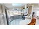 Modern kitchen featuring gray cabinets, stainless steel appliances, and a breakfast bar at 808 Tangerine Woods Blvd, Englewood, FL 34223