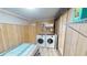 Laundry room with washer, dryer, and extra storage at 808 Tangerine Woods Blvd, Englewood, FL 34223