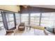 Bright sunroom features wicker furniture and light-colored flooring at 808 Tangerine Woods Blvd, Englewood, FL 34223