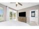 Bedroom with a king-size bed, large TV, and access to bathroom at 8226 Harborside Cir, Englewood, FL 34224