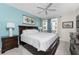 King-size bed in a well-lit bedroom with light blue walls at 8226 Harborside Cir, Englewood, FL 34224