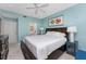 King-size bed in a bedroom with a ceiling fan and adjacent bathroom at 8226 Harborside Cir, Englewood, FL 34224